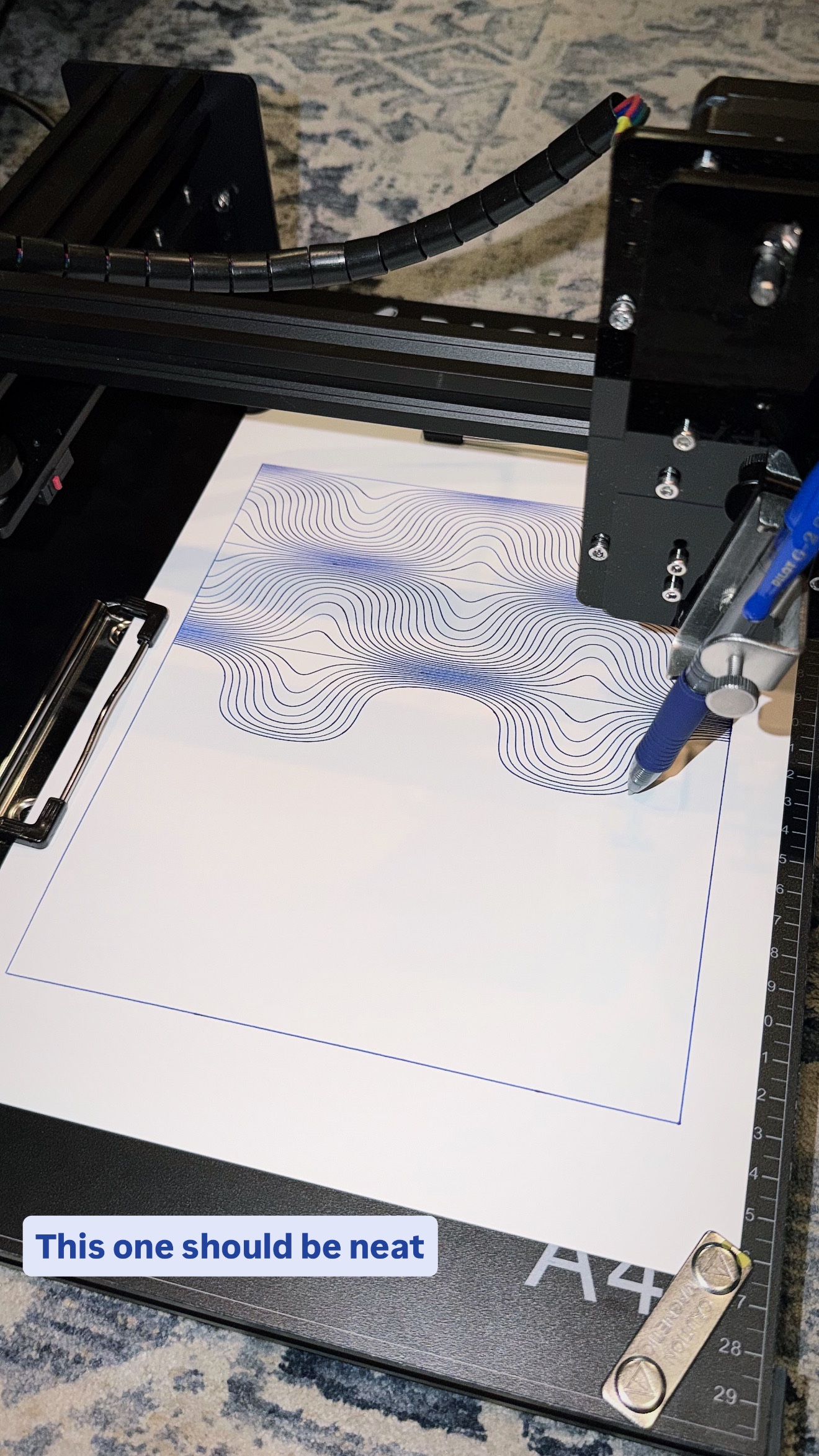 Pen plotter drawing flowing wave lines